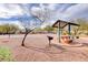 Community playground area featuring a shaded picnic table and barbecue, perfect for outdoor gatherings and Gathering fun at 3313 Jamaica Princess Pl # 3, North Las Vegas, NV 89084