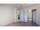 Bedroom featuring plush carpeting, neutral color scheme, closet and ensuite bathroom at 3360 S Rainbow Ave, Pahrump, NV 89048