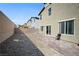 Private backyard showcasing gravel bed and tiled patio area, enclosed with a sturdy block wall at 3807 Andorian Ave, North Las Vegas, NV 89084