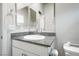Well-lit bathroom showcasing granite counters, white cabinets, and modern fixtures at 3807 Andorian Ave, North Las Vegas, NV 89084