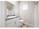 Compact bathroom featuring granite counters, white cabinets, and tiled shower at 3807 Andorian Ave, North Las Vegas, NV 89084
