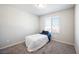 This bedroom features neutral walls, carpet, and a large window at 3807 Andorian Ave, North Las Vegas, NV 89084