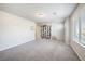 Spacious bonus room features plush carpeting, a window with blinds and a storage area at 3807 Andorian Ave, North Las Vegas, NV 89084