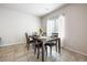 Charming dining room featuring a wooden table and chairs with natural light from the window at 3807 Andorian Ave, North Las Vegas, NV 89084