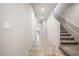 Inviting hallway with tile flooring, staircase, and neutral color palette at 3807 Andorian Ave, North Las Vegas, NV 89084