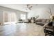 Open-concept living room with tile flooring, ceiling fan, and access to the backyard at 3807 Andorian Ave, North Las Vegas, NV 89084