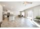 Bright open floor plan showcases tile flooring, modern kitchen, and sliding glass doors to backyard at 3807 Andorian Ave, North Las Vegas, NV 89084