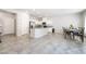 Bright living room view showcases tile flooring, modern kitchen, and a dining area at 3807 Andorian Ave, North Las Vegas, NV 89084