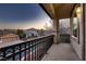 Cozy balcony featuring wrought iron railing offering neighborhood views during a colorful sunset at 3892 Pasilla Ave, Las Vegas, NV 89118