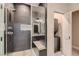 Bathroom features a stand up shower with dark modern tile and a built-in bench at 3892 Pasilla Ave, Las Vegas, NV 89118