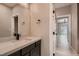 Powder room featuring modern fixtures, a sleek mirror, and black hardware at 3892 Pasilla Ave, Las Vegas, NV 89118