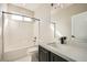 Bright bathroom featuring tiled shower-tub, modern vanity and fixtures, and great lighting at 3892 Pasilla Ave, Las Vegas, NV 89118