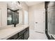 Bathroom features stand up shower with dark modern tile and a large vanity at 3892 Pasilla Ave, Las Vegas, NV 89118