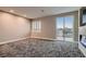 Comfortable carpeted bedroom with plantation shutters and glass door to the balcony at 3892 Pasilla Ave, Las Vegas, NV 89118