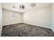 Bedroom with neutral colored walls and a modern ceiling fan above textured carpet flooring at 3892 Pasilla Ave, Las Vegas, NV 89118