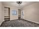Neutral bedroom featuring plush patterned carpet, exterior door, shuttered window, and built in shelving at 3892 Pasilla Ave, Las Vegas, NV 89118