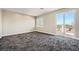 Spacious bedroom featuring plush carpets and a window and glass door to the balcony at 3892 Pasilla Ave, Las Vegas, NV 89118