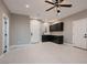 Bonus room featuring whitewashed floors, wet bar with dark cabinetry and great natural light at 3892 Pasilla Ave, Las Vegas, NV 89118