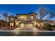 Elegant two-story home featuring a three-car garage, balcony, and well-maintained landscaping at 3892 Pasilla Ave, Las Vegas, NV 89118