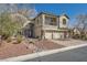 Charming two-story home with arched entrance, well-kept landscape, and brick paved driveway at 3892 Pasilla Ave, Las Vegas, NV 89118