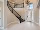 Grand foyer with wrought iron staircase and high ceilings creates an elegant entrance at 3892 Pasilla Ave, Las Vegas, NV 89118
