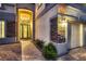 Inviting home entrance with elegant arched doorway and brick pathway leading to front door at 3892 Pasilla Ave, Las Vegas, NV 89118