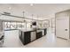 Open kitchen featuring a large island with bar seating, stainless appliances, and sliding glass doors to the pool area at 3892 Pasilla Ave, Las Vegas, NV 89118
