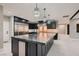 Modern kitchen featuring a large island with bar seating, stainless appliances, and designer lighting at 3892 Pasilla Ave, Las Vegas, NV 89118
