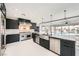 Modern kitchen boasts stainless steel appliances, a large island, and sleek black cabinetry at 3892 Pasilla Ave, Las Vegas, NV 89118