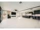 Living room featuring an entertainment center, ceiling fan, and open access to the kitchen at 3892 Pasilla Ave, Las Vegas, NV 89118