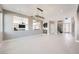 Spacious living room featuring an elegant chandelier and open access to the kitchen and entryway at 3892 Pasilla Ave, Las Vegas, NV 89118