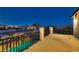 Spacious patio with stone railings and a view of pool and neighborhood at dusk at 3892 Pasilla Ave, Las Vegas, NV 89118