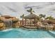 Beautiful pool area with a rock waterfall, tiki bar, and swim-up seating provides a resort-style experience at 3892 Pasilla Ave, Las Vegas, NV 89118