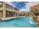 Backyard oasis featuring a sparkling pool with waterfall feature and lush landscaping for relaxation and enjoyment at 3892 Pasilla Ave, Las Vegas, NV 89118