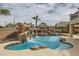 Lush backyard features a pool with rock waterfall, slide, and tiki bar, perfect for outdoor fun at 3892 Pasilla Ave, Las Vegas, NV 89118