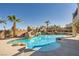 Sparkling backyard pool with rock accents, a slide, and a shaded bar area is perfect for entertaining at 3892 Pasilla Ave, Las Vegas, NV 89118