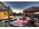 Gorgeous backyard with luxurious pool, grotto spa, outdoor kitchen, and covered patio at 3892 Pasilla Ave, Las Vegas, NV 89118