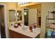 Bathroom featuring vanity, sink, large mirror and shelving at 4047 Cougar Falls Ct, North Las Vegas, NV 89085