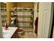 Bathroom with decorative shower curtain, shelving and vanity at 4047 Cougar Falls Ct, North Las Vegas, NV 89085