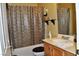 A clean bathroom featuring a patterned shower curtain and vanity with storage underneath at 4047 Cougar Falls Ct, North Las Vegas, NV 89085