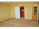 A carpeted bedroom includes an open door to the closet with custom shelves and storage at 4047 Cougar Falls Ct, North Las Vegas, NV 89085