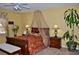 A beautifully decorated bedroom with ceiling fan includes a canopy bed and matching nightstands at 4047 Cougar Falls Ct, North Las Vegas, NV 89085