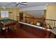 Billiard room featuring a pool table, ceiling fans, and a decorative giraffe statue by the railing at 4047 Cougar Falls Ct, North Las Vegas, NV 89085