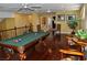 Billiard room with hardwood floors, a ceiling fan, and a view of a bedroom at 4047 Cougar Falls Ct, North Las Vegas, NV 89085