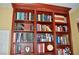 Detailed close-up of a built-in wooden bookshelf filled with books, showcasing craftsmanship at 4047 Cougar Falls Ct, North Las Vegas, NV 89085