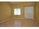 Bright, empty room with tile flooring, neutral walls, and a large double-door closet at 4047 Cougar Falls Ct, North Las Vegas, NV 89085