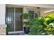 Welcoming front door framed by lush greenery and a stone facade creating a cozy entry at 4047 Cougar Falls Ct, North Las Vegas, NV 89085