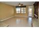 Spacious living room featuring tile flooring, natural light, and a glass door entrance at 4047 Cougar Falls Ct, North Las Vegas, NV 89085