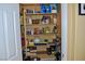 Well-stocked pantry with multiple shelves, displaying a variety of food items and household goods at 4047 Cougar Falls Ct, North Las Vegas, NV 89085