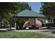 Community park pavilion with picnic tables, climbing wall, and ample shaded seating at 4047 Cougar Falls Ct, North Las Vegas, NV 89085